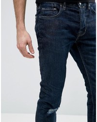 Jeans aderenti strappati blu scuro di AllSaints