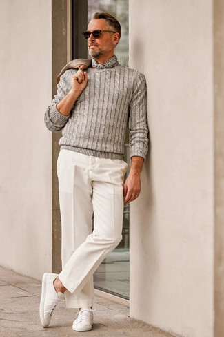 Quale chino indossare con un maglione a trecce grigio: Indossa un maglione a trecce grigio e chino per un look raffinato per il tempo libero. Scegli un paio di sneakers basse di tela bianche come calzature per avere un aspetto più rilassato.