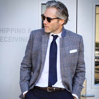 Come indossare e abbinare una cravatta blu scuro per un uomo di 50 anni in estate 2024: Abbina un blazer scozzese grigio con una cravatta blu scuro come un vero gentiluomo. Una splendida idea per essere molto elegante e assolutamente alla moda anche in estate.