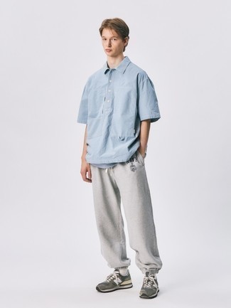 Look alla moda per uomo: Camicia a maniche corte azzurra, Pantaloni sportivi grigi, Scarpe sportive marroni, Calzini bianchi