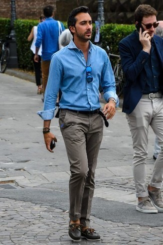 Come indossare e abbinare occhiali da sole blu per un uomo di 30 anni: Per un outfit della massima comodità, prova a combinare una camicia a maniche lunghe in chambray azzurra con occhiali da sole blu. Un bel paio di scarpe da barca in pelle nere è un modo semplice di impreziosire il tuo look.
