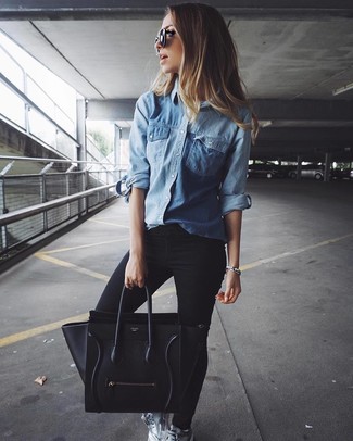 Look alla moda per donna: Camicia di jeans blu, Jeans aderenti neri, Sneakers basse in pelle argento, Borsa shopping in pelle nera