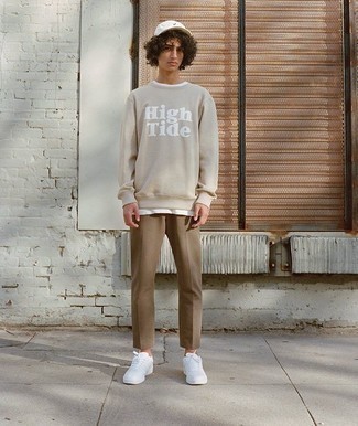 Look alla moda per uomo: Felpa stampata beige, T-shirt girocollo bianca, Chino marrone chiaro, Sneakers basse in pelle bianche