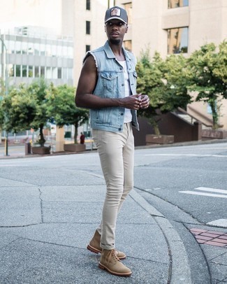 Look alla moda per uomo: Gilet di jeans azzurro, Canotta bianca, Jeans aderenti beige, Stivali casual di tela marrone chiaro