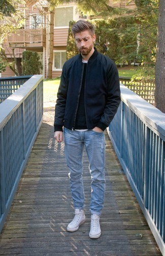 Quale maglione girocollo indossare con jeans azzurri per un uomo di 20 anni quando fa caldo in modo rilassato: Scegli un maglione girocollo e jeans azzurri per un look comfy-casual. Per distinguerti dagli altri, calza un paio di sneakers alte di tela bianche.