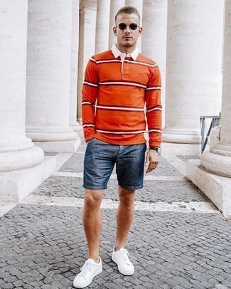 Come indossare e abbinare una maglia a polo arancione per un uomo di 20 anni in modo smart-casual: Vestiti con una maglia  a polo arancione e pantaloncini di lino blu scuro per un look davvero alla moda. Se non vuoi essere troppo formale, calza un paio di sneakers basse di tela bianche.