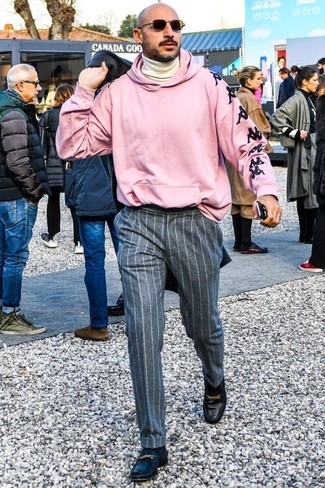Look alla moda per uomo: Soprabito grigio scuro, Felpa con cappuccio stampata rosa, Dolcevita beige, Pantaloni eleganti di lana a righe verticali grigi