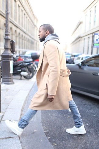 Look di Kanye West: Soprabito marrone chiaro, Felpa con cappuccio grigia, Jeans aderenti azzurri, Sneakers alte in pelle bianche