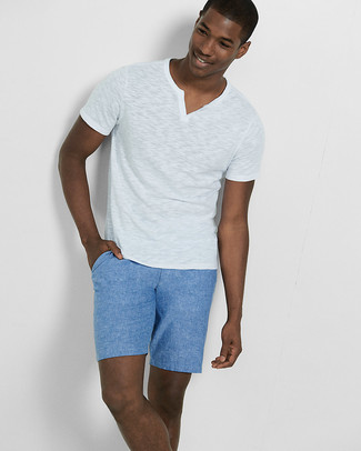 Come indossare e abbinare pantaloncini blu scuro per un uomo di 20 anni: Potresti combinare una t-shirt con scollo a v bianca con pantaloncini blu scuro per un look spensierato e alla moda.