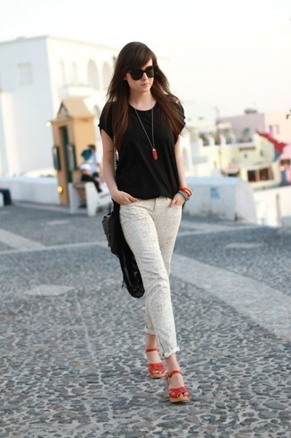 Quale jeans aderenti indossare con una t-shirt girocollo nera: Abbina una t-shirt girocollo nera con jeans aderenti per vestirti casual. Sandali con zeppa in pelle rossi sono una valida scelta per completare il look.