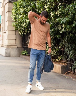 Quale jeans indossare con una t-shirt girocollo beige per un uomo di 30 anni: Coniuga una t-shirt girocollo beige con jeans per un look spensierato e alla moda. Questo outfit si abbina perfettamente a un paio di sneakers basse in pelle bianche.