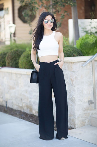 Come indossare e abbinare pantaloni larghi neri quando fa molto caldo: Indossa un top corto bianco con pantaloni larghi neri per un look raffinato ma semplice.