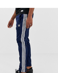 Pantaloni sportivi a righe verticali blu scuro di adidas Originals