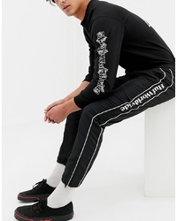 Pantaloni sportivi a righe verticali neri e bianchi di HUF