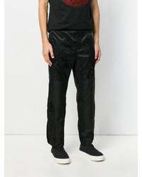 Pantaloni stampati neri di Versace