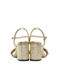 Sandali con tacco in pelle dorati di Gucci
