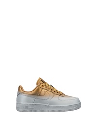 Sneakers basse stampate dorate