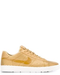 Sneakers in pelle dorate di Nike