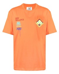 T-shirt girocollo arancione di New Balance