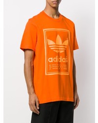 T-shirt girocollo stampata arancione di adidas
